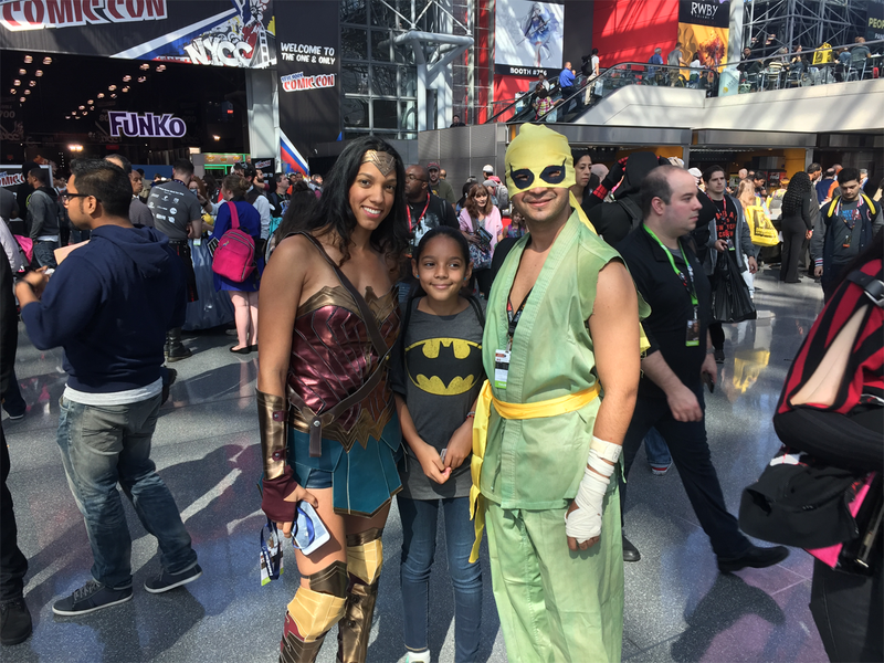 Wonder Woman and Iron Fist pose with a fan.